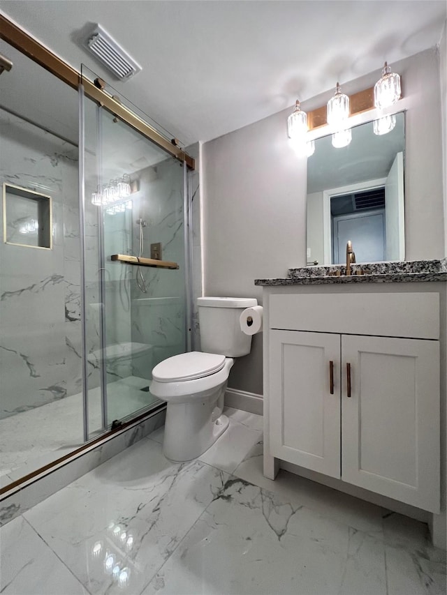 bathroom with vanity, toilet, and a shower with door