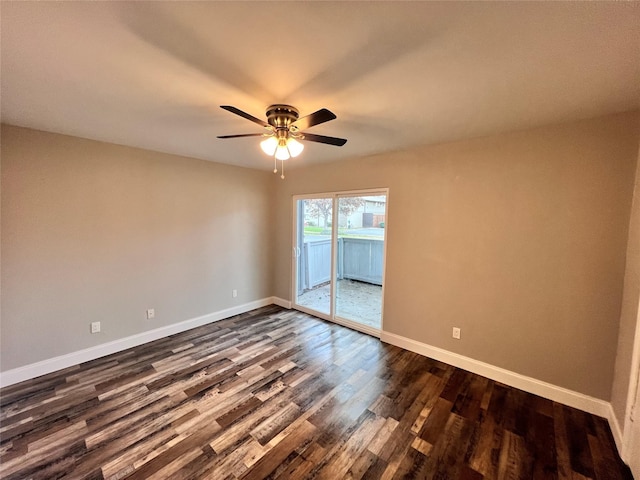 empty room with ceiling fan and dark hardwood / wood-style flooring