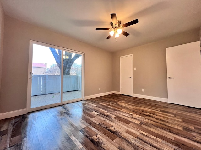 spare room featuring dark hardwood / wood-style flooring and ceiling fan