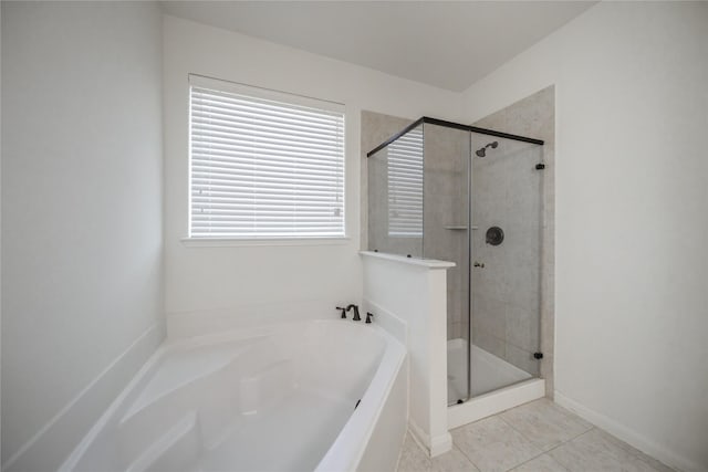 bathroom with tile patterned floors and independent shower and bath