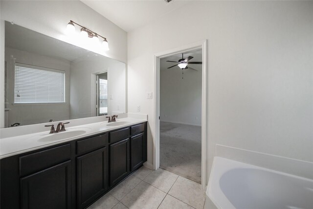 bathroom with ceiling fan, tile patterned floors, vanity, and a bath