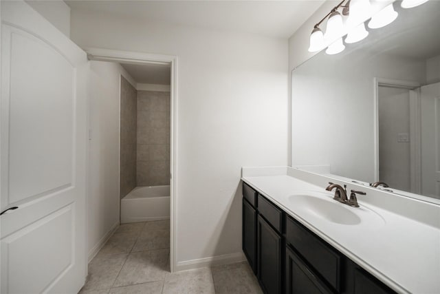 bathroom featuring vanity, tiled shower / bath combo, and tile patterned flooring