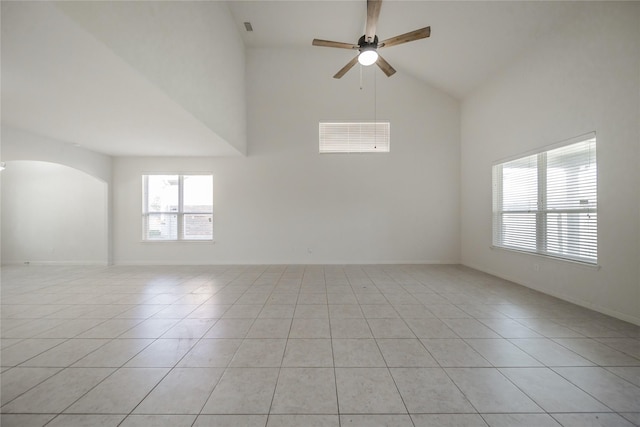 tiled spare room featuring ceiling fan and high vaulted ceiling