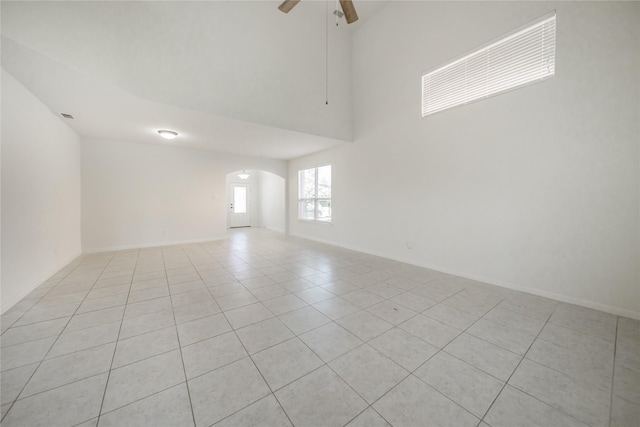 empty room with light tile patterned floors and ceiling fan