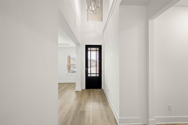 foyer featuring a towering ceiling and light hardwood / wood-style floors