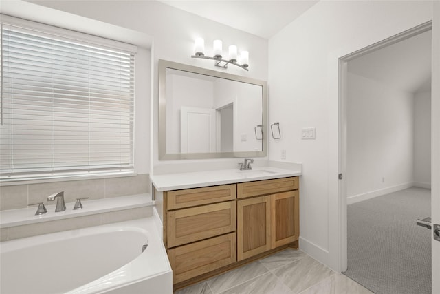 bathroom with vanity and a bath