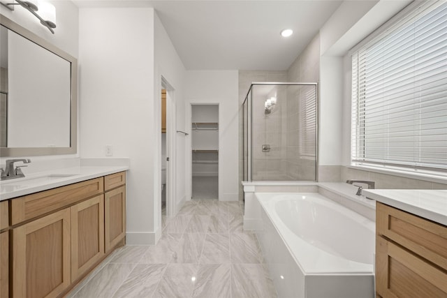 bathroom with vanity and separate shower and tub