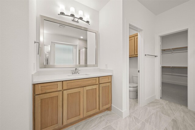 bathroom with vanity, toilet, and walk in shower