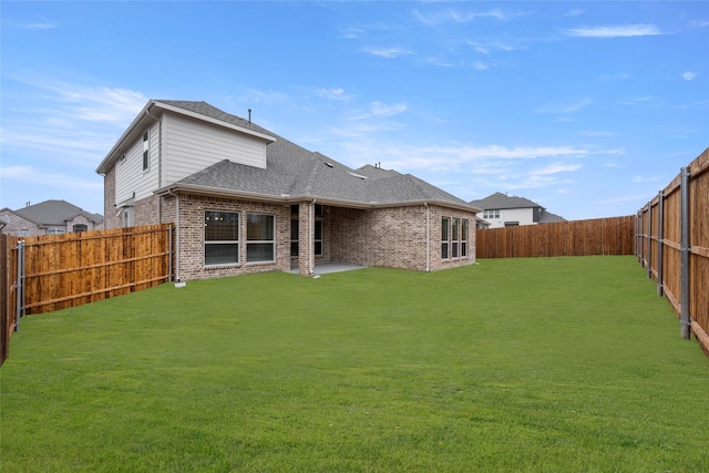 rear view of property featuring a lawn