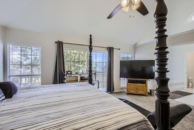 bedroom featuring multiple windows, ceiling fan, light carpet, and vaulted ceiling