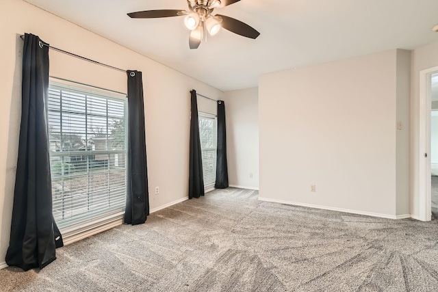 carpeted spare room with ceiling fan