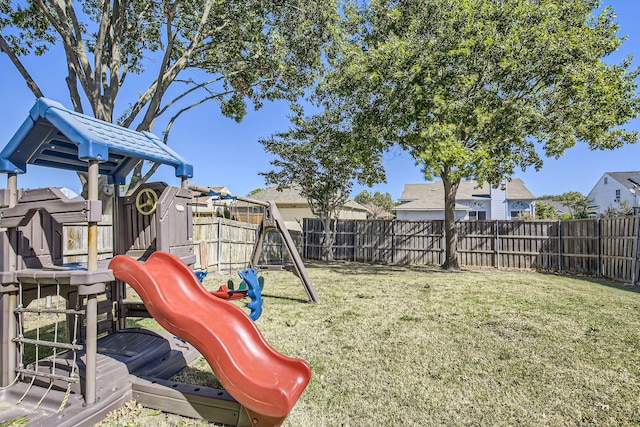 view of jungle gym featuring a lawn