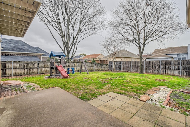 view of yard with a playground and a patio area