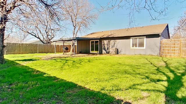 rear view of property featuring a lawn and a patio