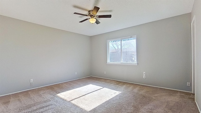 spare room featuring ceiling fan and light colored carpet