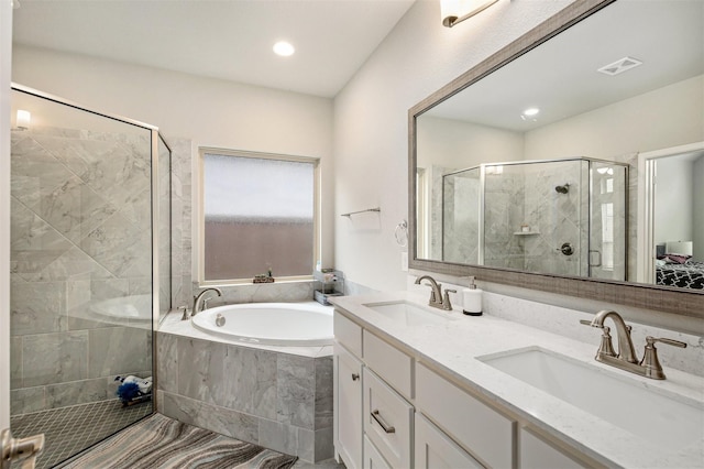 bathroom with vanity and independent shower and bath