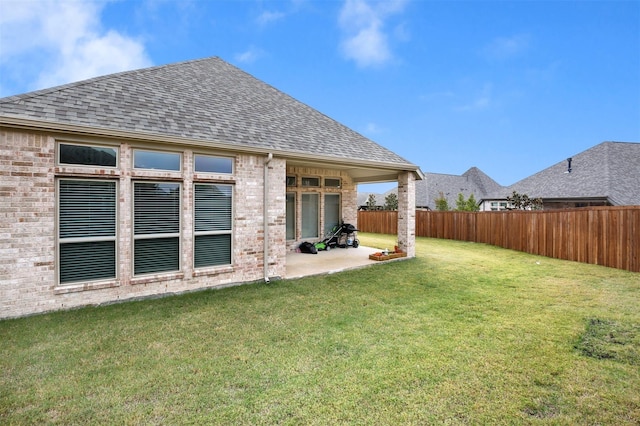 back of property featuring a patio and a yard