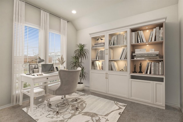 office area with carpet floors and vaulted ceiling