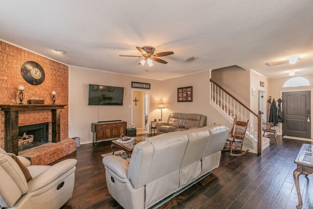 living room featuring ornamental molding, a textured ceiling, and dark wood-type flooring