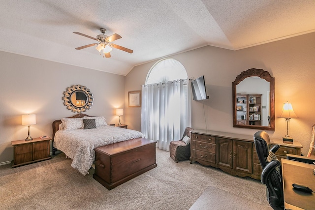 carpeted bedroom featuring ceiling fan, lofted ceiling, and a textured ceiling