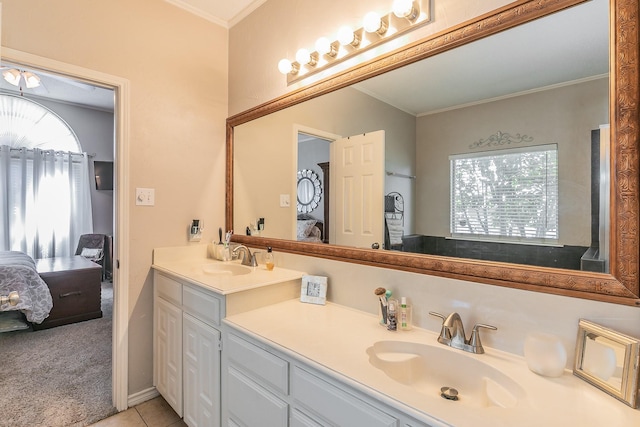 bathroom featuring tile patterned floors, crown molding, and vanity