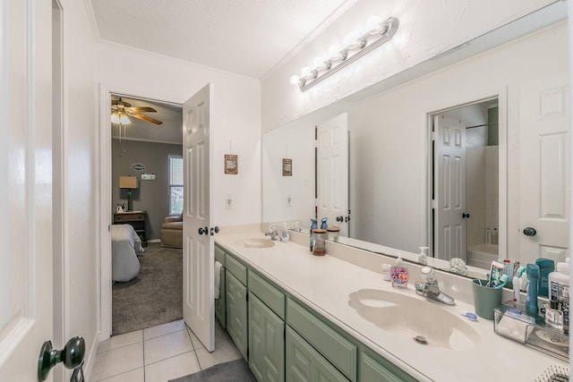 bathroom featuring ceiling fan, tile patterned flooring, a textured ceiling, vanity, and ornamental molding