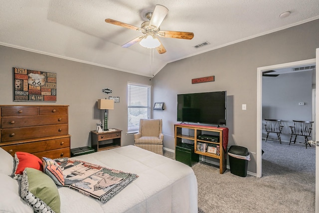 carpeted bedroom with vaulted ceiling, ceiling fan, and crown molding