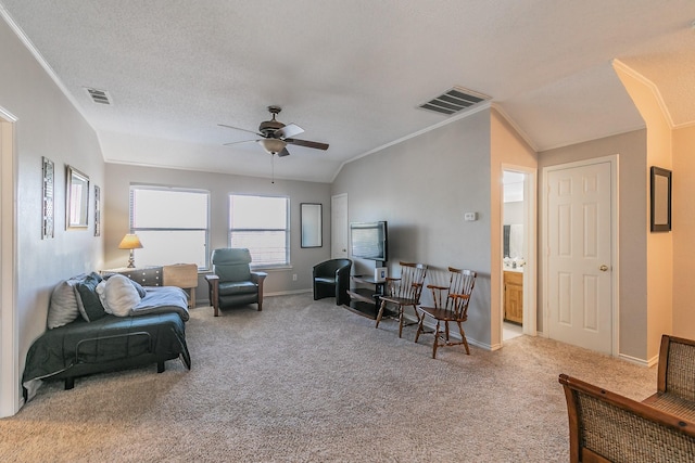 living room featuring carpet flooring, crown molding, ceiling fan, and lofted ceiling