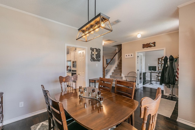 dining room with ornamental molding and dark hardwood / wood-style floors