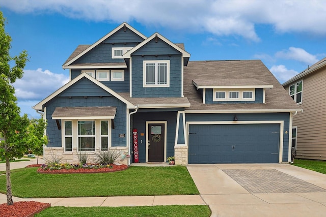 craftsman inspired home with a front yard and a garage