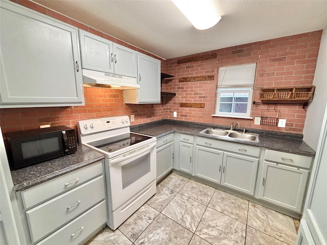 kitchen featuring white range with electric stovetop, sink, brick wall, and a textured ceiling