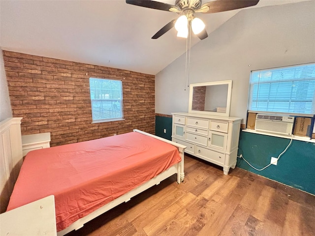 bedroom featuring hardwood / wood-style floors, cooling unit, vaulted ceiling, ceiling fan, and multiple windows