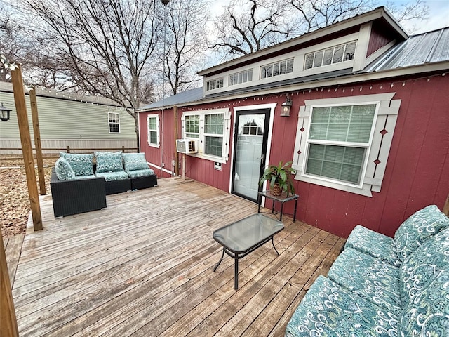 wooden deck with cooling unit and an outdoor hangout area