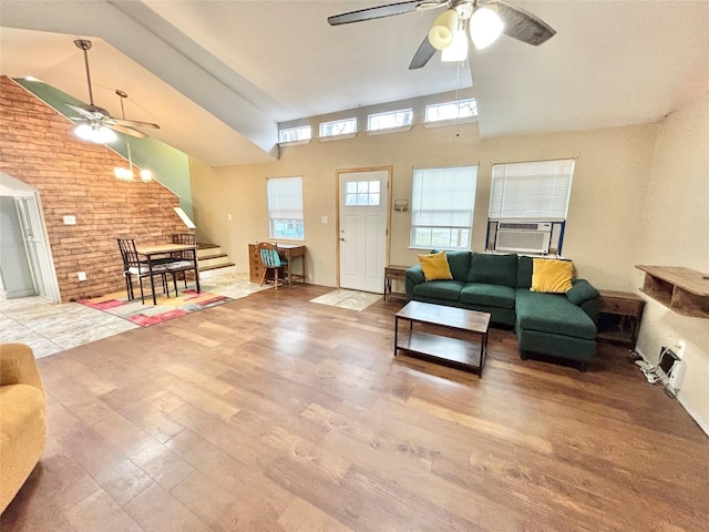 living room featuring a wealth of natural light, light hardwood / wood-style floors, a high ceiling, and cooling unit