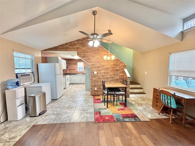 dining room featuring light hardwood / wood-style floors, ceiling fan, and lofted ceiling