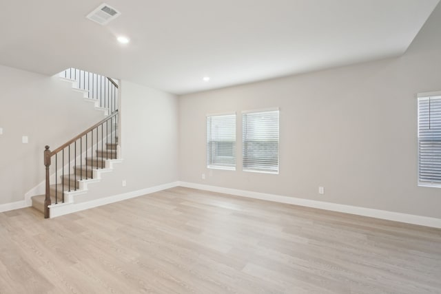 empty room with light hardwood / wood-style floors