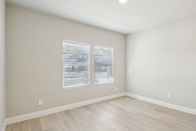 spare room with light wood-type flooring