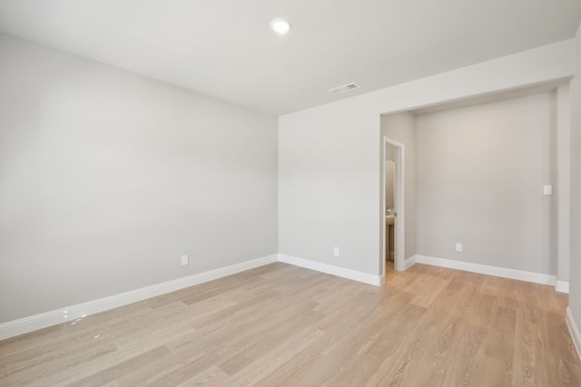 empty room with light hardwood / wood-style flooring