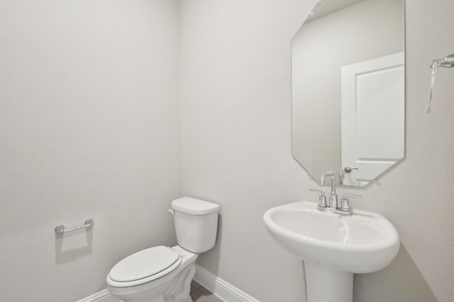 bathroom featuring sink and toilet