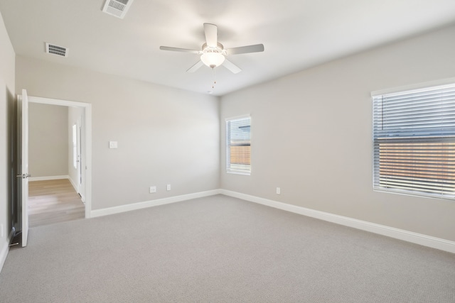 carpeted empty room featuring ceiling fan