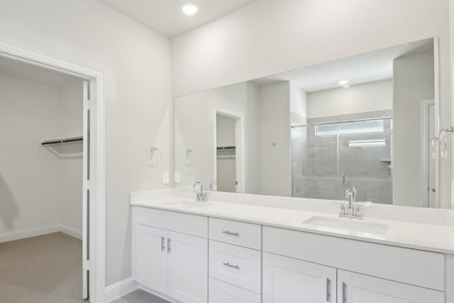 bathroom featuring vanity and a shower with door