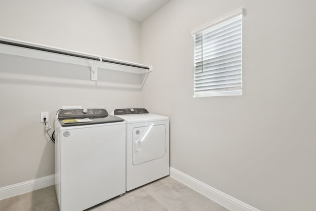 laundry room with light tile patterned floors and washing machine and dryer