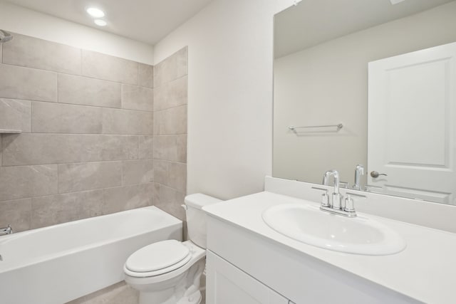 full bathroom featuring toilet, tiled shower / bath, and vanity