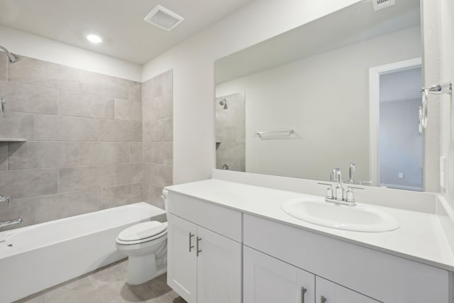 full bathroom featuring toilet, tiled shower / bath, and vanity