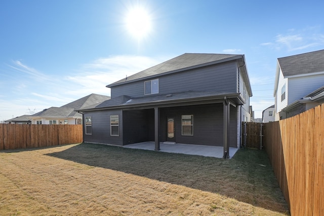 rear view of property featuring a yard and a patio