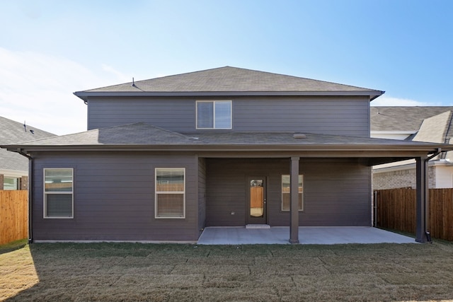 back of property featuring a patio area and a yard