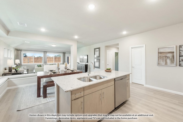 kitchen featuring dishwasher, light brown cabinets, sink, light hardwood / wood-style flooring, and an island with sink