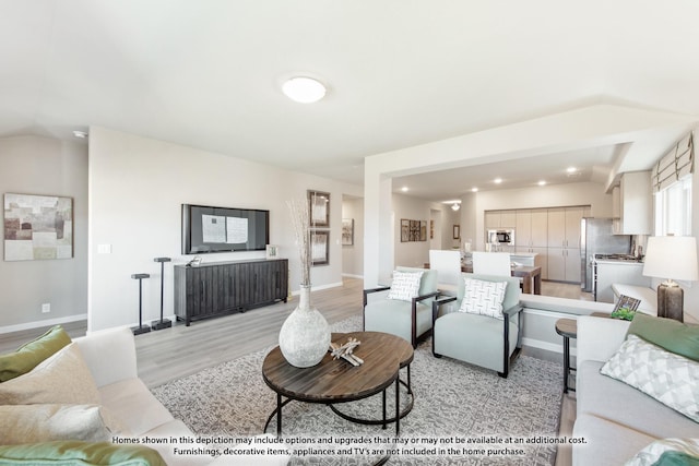 living room featuring light hardwood / wood-style flooring and lofted ceiling