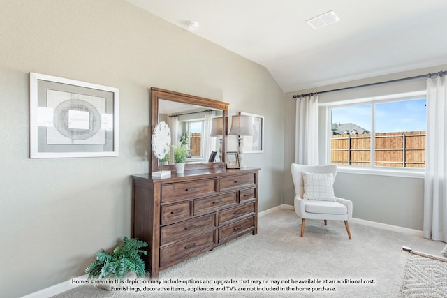 living area with light colored carpet and vaulted ceiling