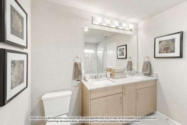 bathroom with vanity, toilet, and a shower with door